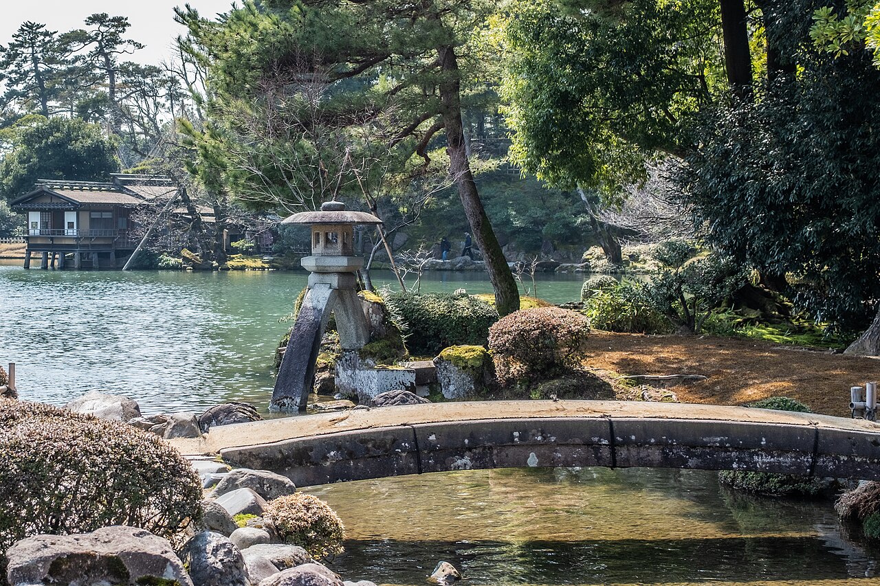 The Kotojitoro stone lantern and a small stone bridge over a pond in Kenroku-en Garden